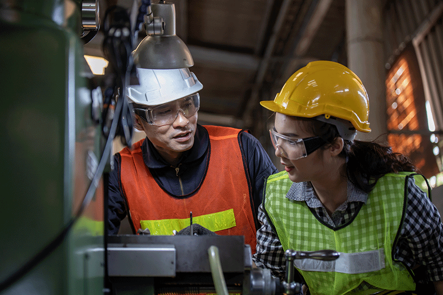 Two facilities management suppliers working in a manufacturing facility